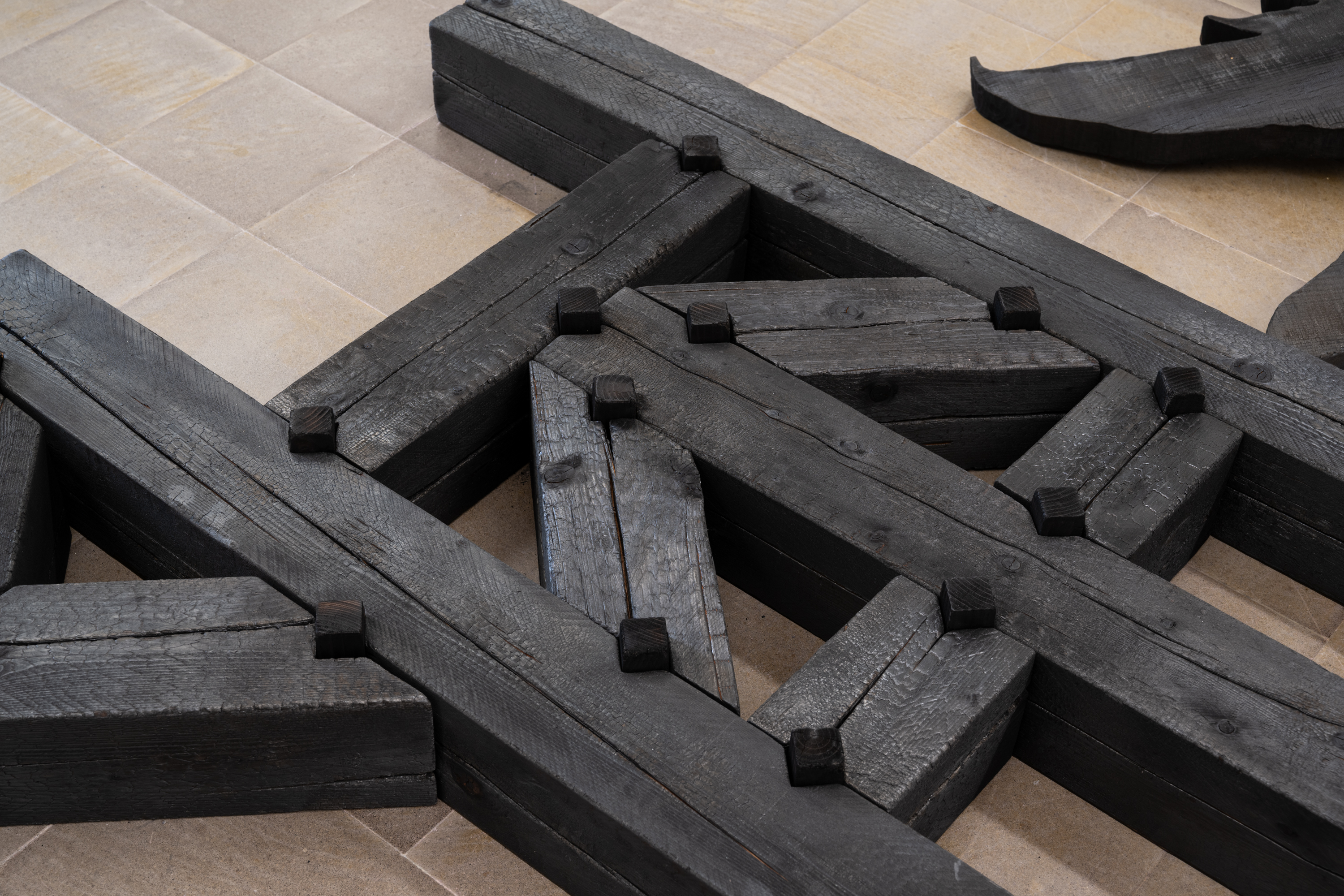 Luzi Paulin Simeon, *Lifelover*, 2026. Burnt wood, 20 × 550 × 370 cm. Photo: Finn Curry.