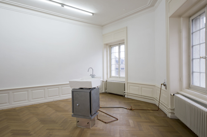 A tap running flow of water that splashes endlessly, and then down into the drain, 2017